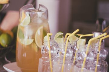 Pitcher of margaritas with bear bottles for serving to guests at a party